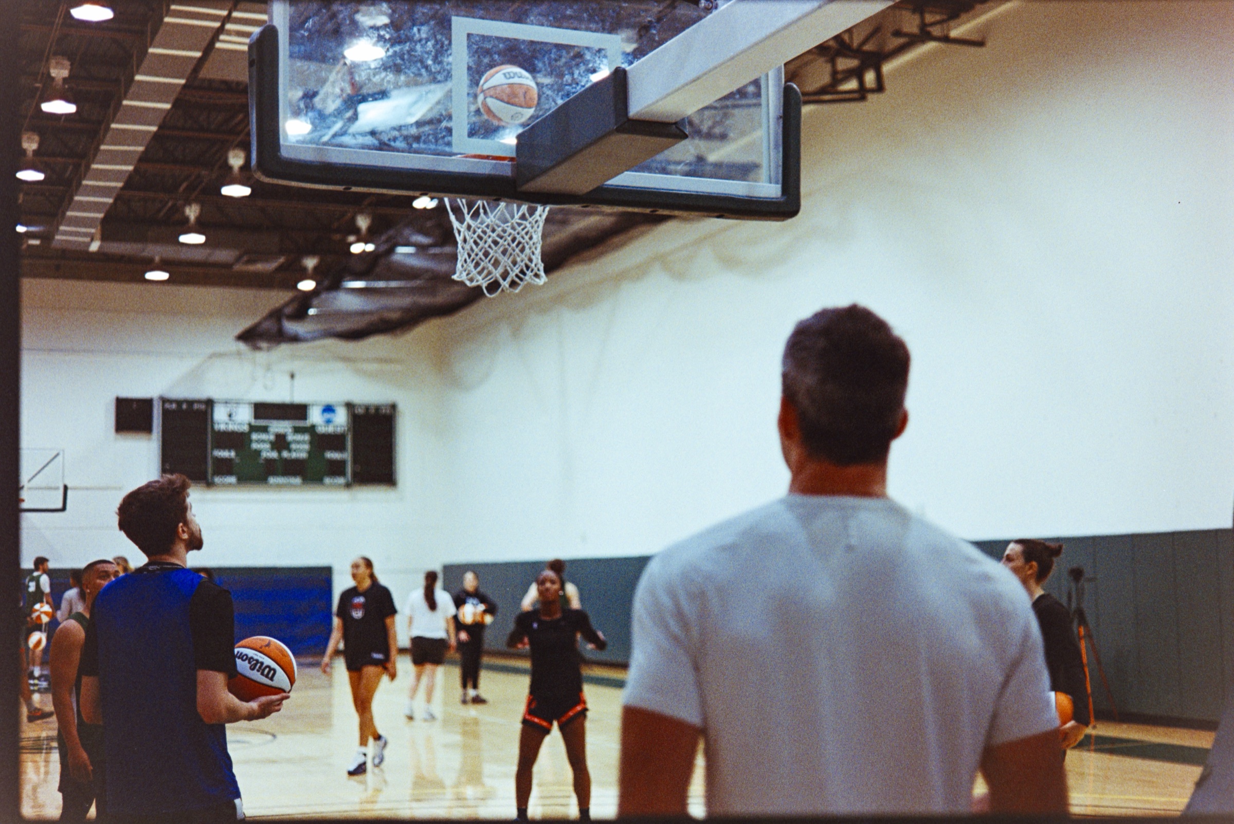 Athletes training on an indoor basketball court